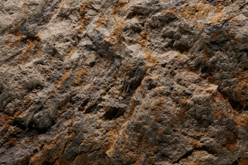 Brown stone texture, dark abstract background. Natural mineral rock close up details, empty backdrop with copy space for design