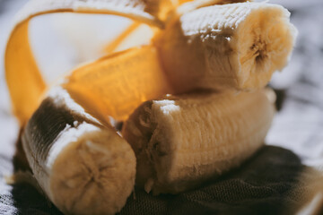 Close-up of peeled bananas on a dark background