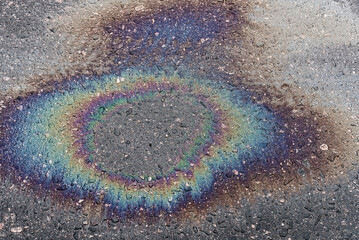 Fototapeta na wymiar Petrol Oil Pollution Rainbow Gasoline Leak on Pavement