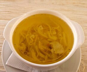 Broth - chicken soup with noodles in a bowl