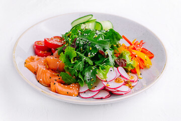 Smoked or salted salmon salad with cucumbers, arugula, peppers and radishes