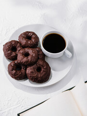 cookies in chocolate glaze with cup of coffee