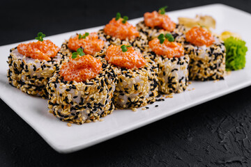 sushi rolls with salmon pieces and red caviar