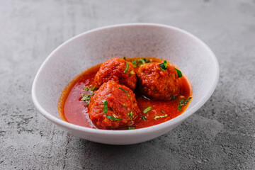 Meatballs with tomato sauce and parsley