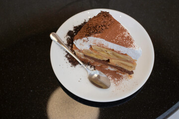 Banoffee cake with bananas and whipped cream in cafe restaurant