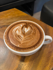 Hot latte coffee with heart in coffee cup