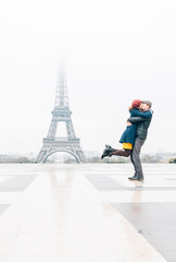 Couple kissing in front of Eiffel Tower