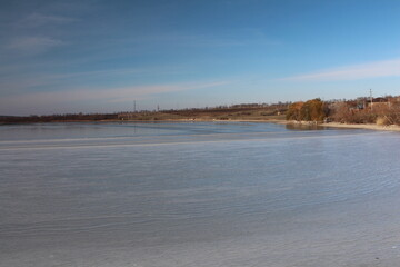 A body of water with trees in the background