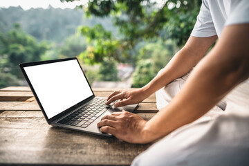 Naklejka premium Working on a laptop on the balcony of a country house