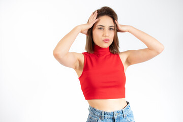 Fototapeta premium Worried perplexed displeased puzzled young brunette woman 20s wearing yellow casual t-shirt posing standing looking camera put hand on head isolated on white background studio portrait