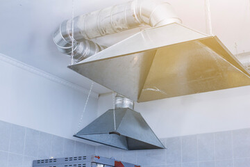 ventilation umbrella in the kitchen in the food preparation area and table close-up