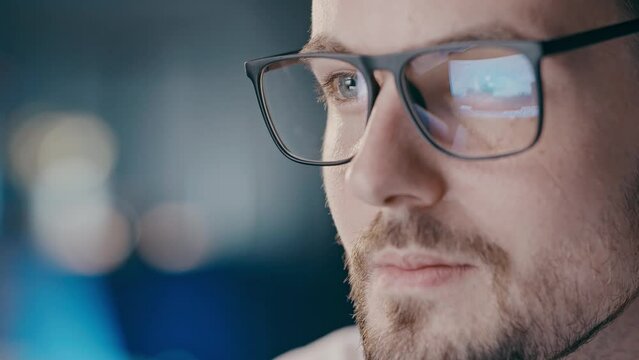 Close up shot glasses reflection statistcs how many bombs and rockets attacked Ukraine in first days of russian invasion. Concentrated on analyzing news man trying to understand russia war logic. Non