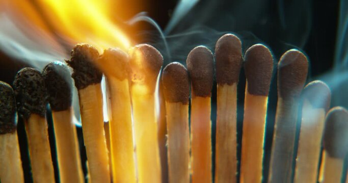 Matches, fire and burning flame on black background for heat, light and lighting wood in dark studio. Orange spark, flammable element and closeup of matchstick for warmth, power blackout and smoking