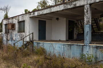 Abandoned office building on end of loading dock of closed down factory in the rural south
