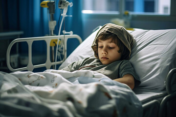 Sad little boy cancer patient lying alone in a hospital room.