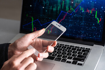 business, statistics, people and future technology concept - close up of businessman hand with charts on transparent smartphone screen and virtual projections over black background.