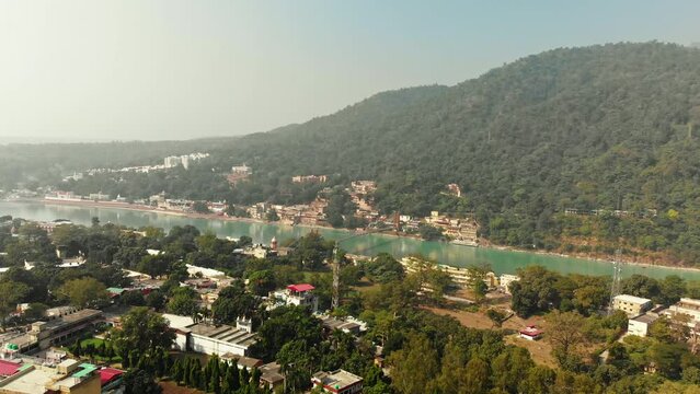 Aerial/Drone shot of Rishikesh City, Ram Jhula bridge situated on Holy River Ganga in Rishikesh, holy town and travel destination in India, Hindus capital 4k