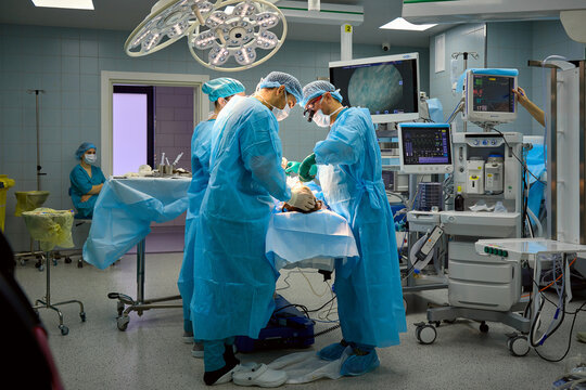 team of surgeons operate on the patient