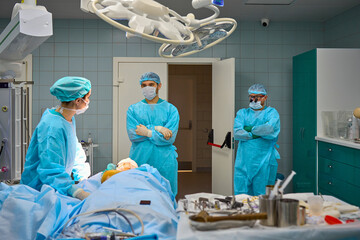 team of surgeons operate on the patient