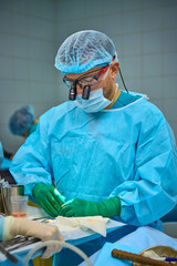 team of surgeons operate on the patient