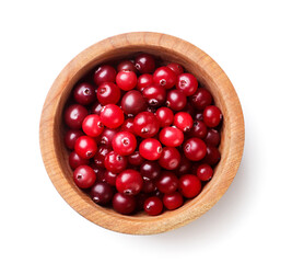 Cranberries in a wooden plate close-up on a white. Top view