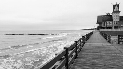 Sea landscape with steps to the Baltic sea and wooden buildings.