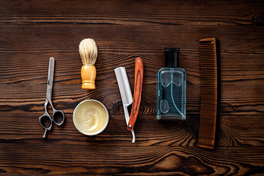 Male beauty products with perfume and barber tools, top view