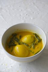 Curry chicken egg with bean bean in the bowl with white background. Delicious food for lunch and dinner. Gulai telur