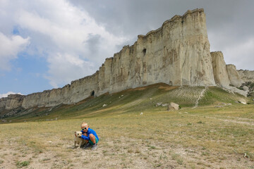 A boy on the background of a landscape view of the White Mountain in the Eastern Crimea. Photos of...