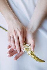 Close-up of a woman's hands holding a flower wedding photo