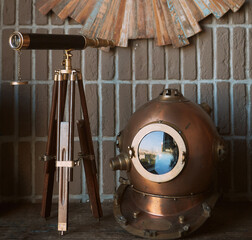 Still life retro diver's helmet and telescope tube