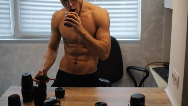 bare-chested man cleans and cares for optics and camera lenses.