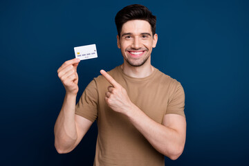 Photo of positive optimistic joyful man wear beige stylish clothes recommend use bank credit card...