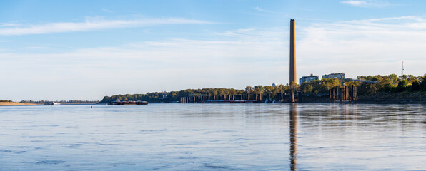 Large barges pass in front of New Madrid power station in Missouri on the Mississippi river in...