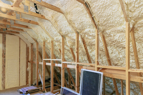Wall of new house under construction is insulated with spray foam thermal hydro insulation
