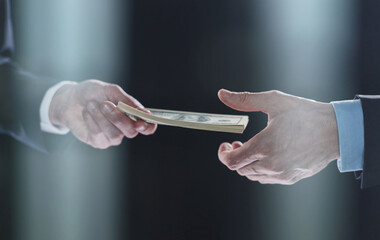 exchange of money cards between businessmen, close-up