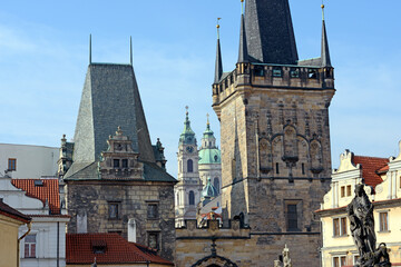 Saint Nicholas Cathedral between towers of Charles Bridge in Prague.