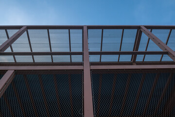 construction detail of building with gallery and steel structure, fall protection nets instead of...