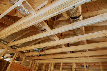 Skeletal construction interior view of new house under wooden framing progress