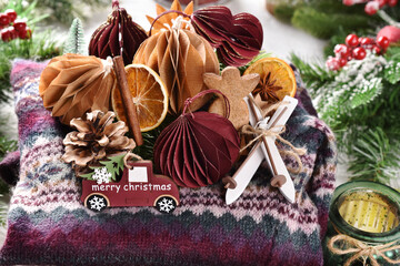 Christmas still life with handmade paper ornaments on colorful woolen sweater