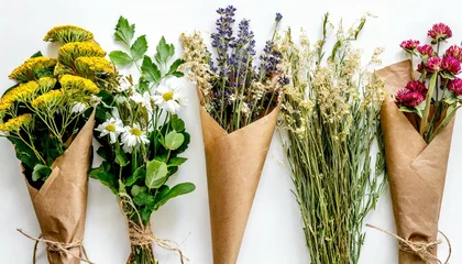 Foto op Canvas flowers in bunches herbs dried flowers in kraft packaging on white background top view space for text high quality photo © Mary