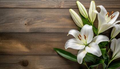 white lily flowers on wooden background top view with copy space funeral concept