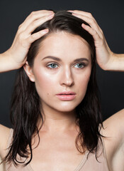 Naklejka premium Lovely brunette woman portrait. Beautiful spa model with perfect fresh clean skin. Youth and skin care concept. Nude makeup