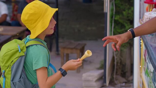 Witness the sheer delight of a little boy as he tries to grab a Turkish ice cream, while the playful seller engages in entertaining tricks to cheer him up. The lively scene captures the essence of