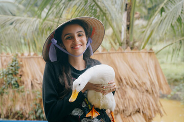 tourist holds a duck at the duck stop in Phong Nha, Vietnam.