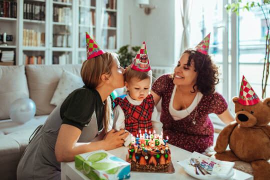 Lesbian parents celebrating little girls birthday at home