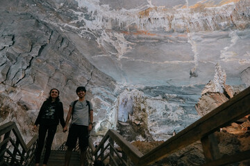 couple inside Phong Nha Cave in Vietnam.
