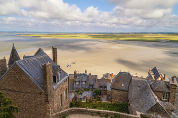 Mont Saint Michel, France. View to the village, central square, old historical houses and low tide...