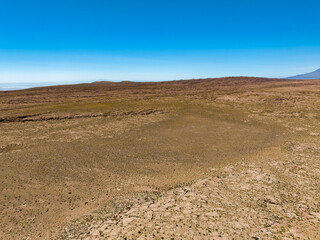 Região desértica ao lado do vilarejo de Socaire no Chile. Areia, dunas, céu azul e paisagem árida.