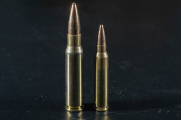 Macro photo of rifle cartridges of 5.56x45mm and 7.62x51mm caliber.